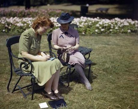 Two-women,-responding-to-the-'Holidays-at-Home'-campaign,-writing-post-cards-in-Hyde-Park,-London Two-women,-responding-to-the-'Holidays-at-Home'-campaign,-writing-post-cards-in-Hyde-Park,-London