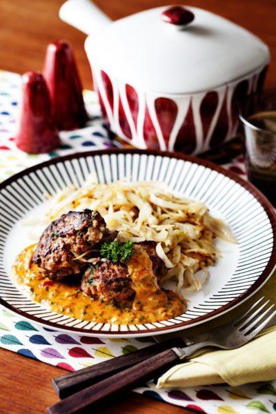 Keto hamburger patties with creamy tomato sauce and fried cabbage