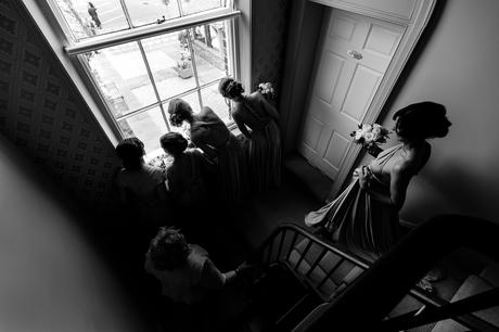 Bridesmaids look out window at york wedding