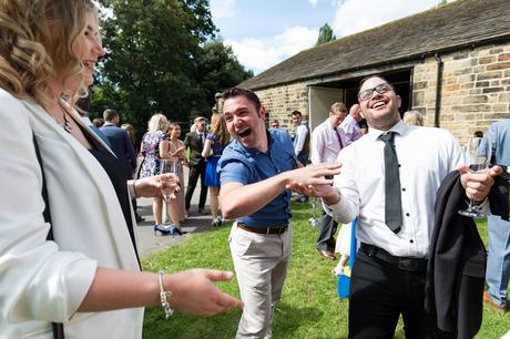 Guests laughing at east riddlesden hall wedding
