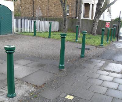 Ten Green Bollards Standing On...