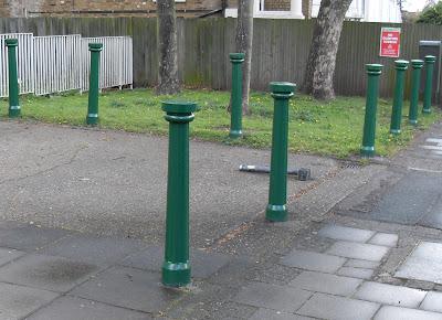 Ten Green Bollards Standing On...