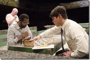 (Right) Rey Reyes (Raúl Castillo) ends his turn in a match against chess hustler Cash (Cedric Mays) while fellow hustler John (Mike Cherry) watches in Teatro Vista’s Fish Men, written by Cándido Tirado and presented by Goodman Theatre (April 7 – May 6).