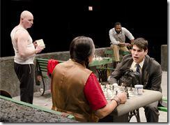  (Center) Jerome (Ricardo Gutierrez) bestows his chess wisdom upon Rey Reyes (Raúl Castillo) while (L to R) John (Mike Cherry) and Cash (Cedric Mays) size him up in Teatro Vista’s Fish Men, written by Cándido Tirado and presented by Goodman Theatre (April 7 – May 6).