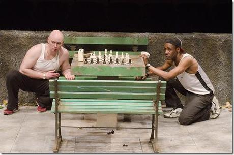  (L to R) Chess hustlers John (Mike Cherry) and PeeWee (Kenn Head) watch a chess match from afar in Teatro Vista’s Fish Men, written by Cándido Tirado and presented by Goodman Theatre (April 7 – May 6).