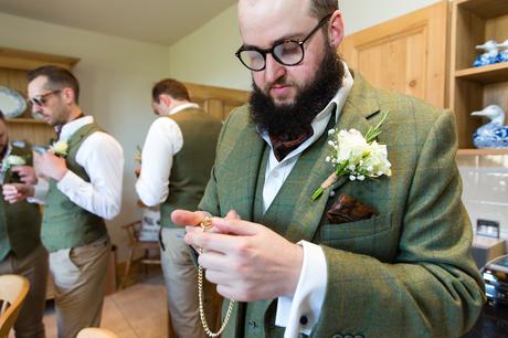 York Wedding Photography at Barmbyfield Barns groom looking at pocket watch gift