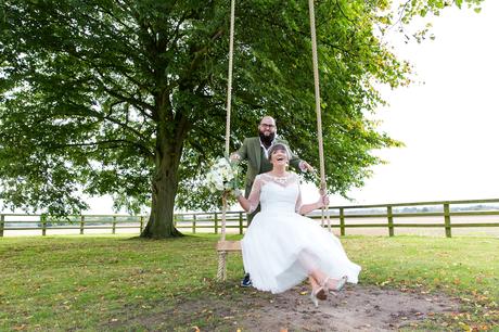 York Wedding Photography at Barmbyfield Barns groom pushes bride on swing