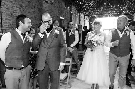 York Wedding Photography at Barmbyfield Barns bride walks up to top of aisle as groom cries