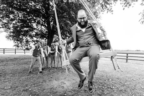 York Wedding Photography at Barmbyfield Barns funny photo of groom on swing