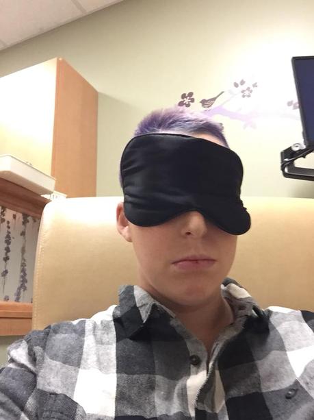 A photo of the author wearing an eye mask at the hospital.