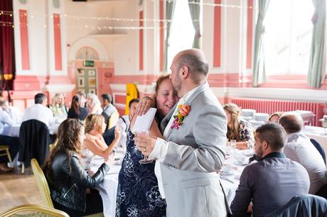 Emotional hug from groom to firend at Victoria Hall wedding