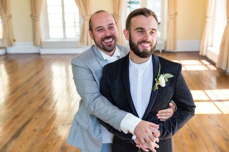 A fun Yorkshire Wedding grooms cuddling in ballroom