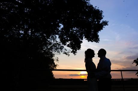 Bride & groom in silhouette by gate Villa Farm Weddings