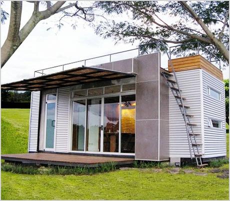tiny glass walled container home features rooftop deck