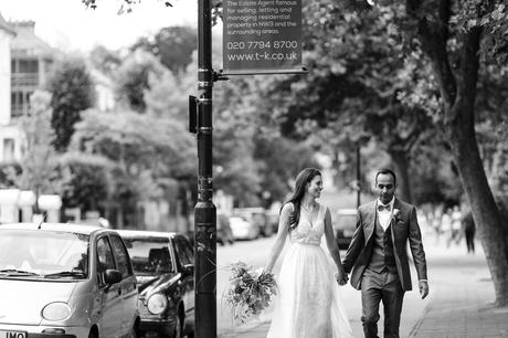 St. Stephens Hampstead Wedding bride and groom walk up the street in Hamstead