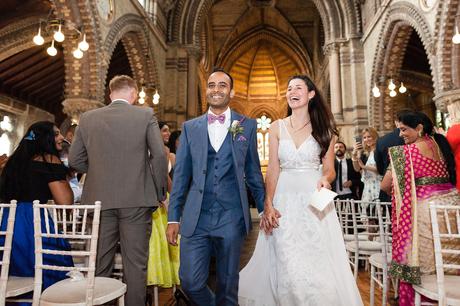St. Stephens Hampstead Wedding bride and groom walk up aisle smiling and laughing