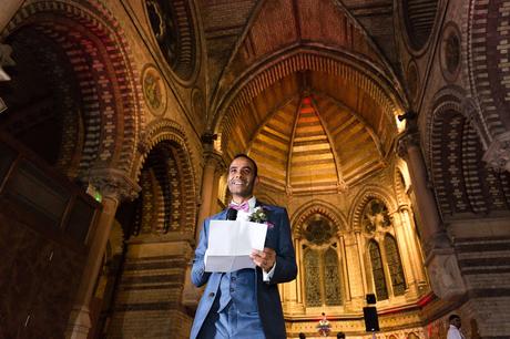 Groom giving speech in front of church backdrop St Stephens Hampstead Wedding Photography