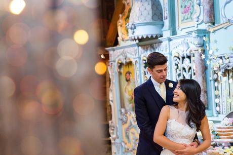 Coupel pose in front of circus wall Preston Court Wedding Photography