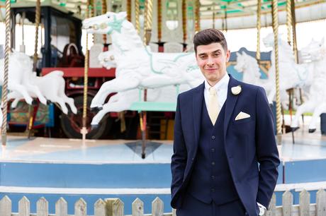 Groom in front of carousel
