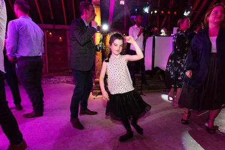 Little girl dances at wedding