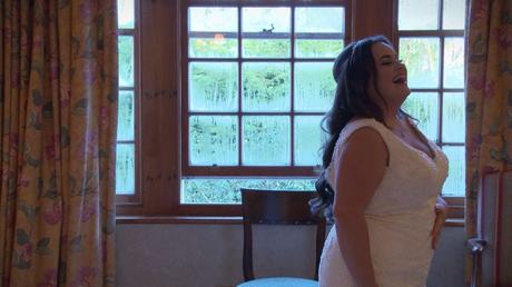 The bride laughs as she tries to pose for her wedding photographer at Nunsmere Hall