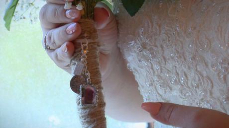 a close up shot of the locket pendant of the brides Dad tied on to her hand tied silk bridal bouquet