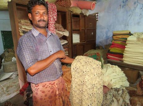 A worker shows the half processed Kalamkari fabric