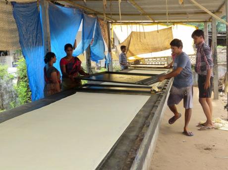 Workers manufacturing Kalamkari fabric using screen printing techniques