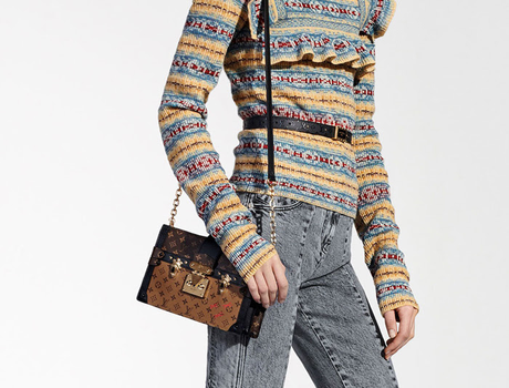 Courtesy purse blog. Tan and Black Louis Vouitton satchel hanbag styles with multicolored top and blue jeans