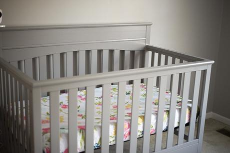 Gray crib for a baby girl nursery. 