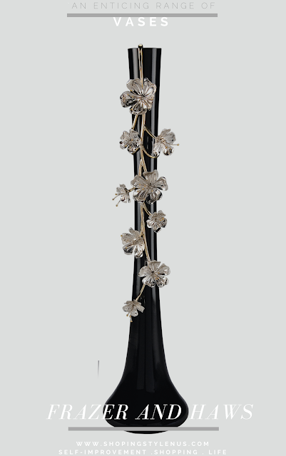 A porcelain vase in black with silver plated vine and floral blossoms. INR 14,900 