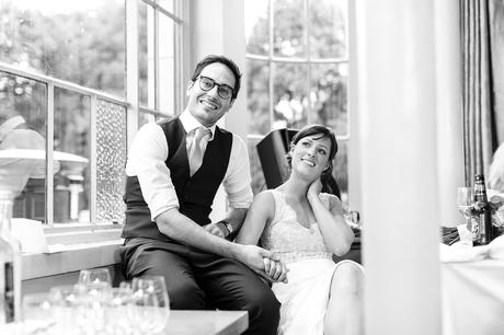 Bride & groom smile and watch during speeches