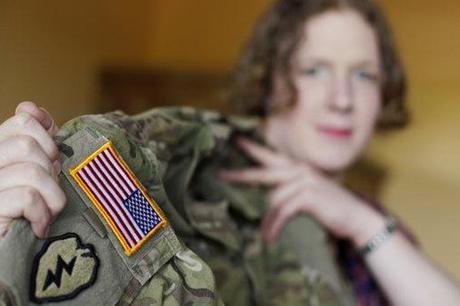 Transgender U.S. Army Capt. Jennifer Sims lifts her uniform