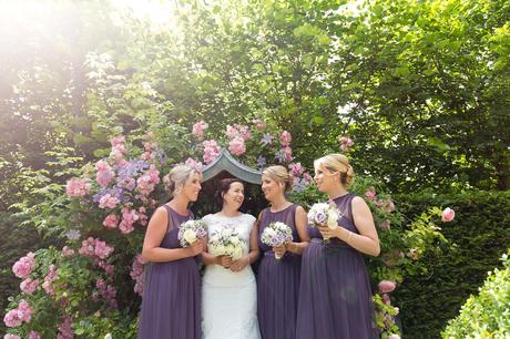 Bell Hall Wedding Photography bride and bridesmaids in purple dresses in front of hydrangeas