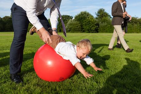 Fun wedding photography kid rolling over spacehopper