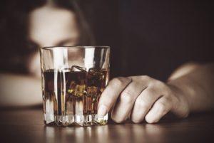 drugabuse-shutterstock293848514-woman_in_front_of_alcohol_glass-feature_image-alcohol_abuse