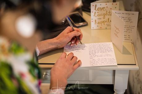 Bride writing card to her Groom