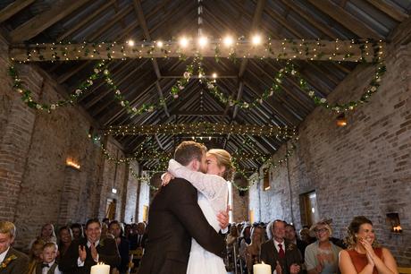 Yorkshire Wedding Photographers at Barmbyfield Barn big first kiss under fairy lights