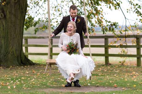 Barmbyfield Barn Wedding Photography Autumnal wedding bride and groom on swing