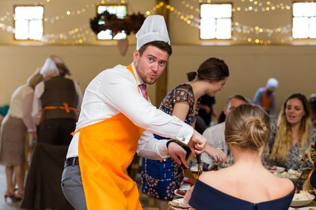 Yorkshire Wedding Photographers at Barmbyfield Barn guest makes funny face whilst carving meat