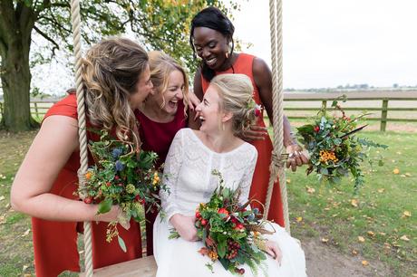 Yorkshire Wedding Photographers at Barmbyfield Barn smiling and laughing with bridesmaids