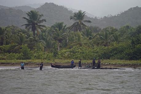 fishermen on beach with net