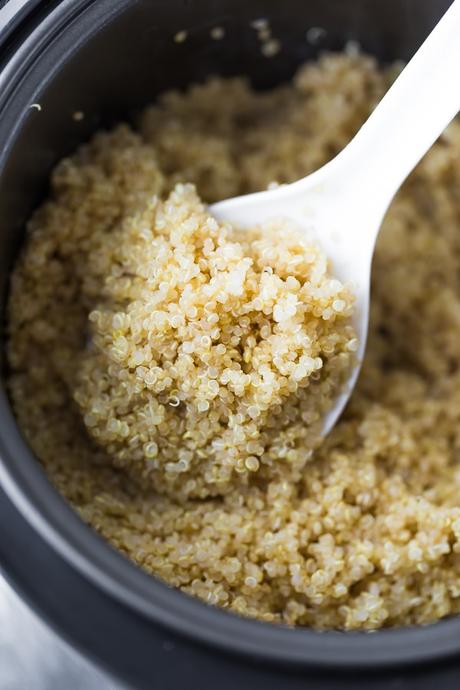 How to Cook Quinoa in a Rice Cooker; close up of the spoon in the rice cooker