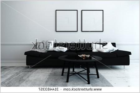 stock photo sparsely decorated modern living room with black sofa coffee table and artwork hanging on wall