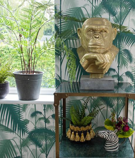 Tropical living room inspiration featuring a monkey statue by Audenza and Palm Jungle wallpaper by Cole & Son