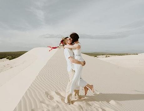 best places to elope sand married couple kiss