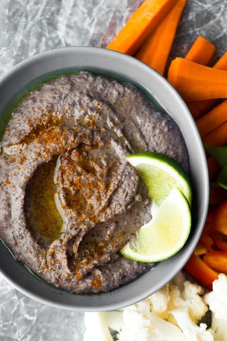 5 Minute Black Bean Hummus in bowl with vegetables surrounding