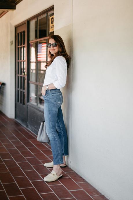 Amy Havins wears a white blouse and jeans.