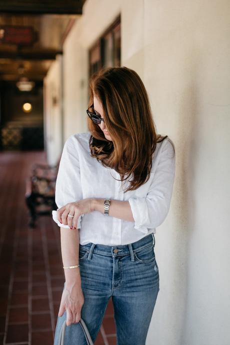 Amy Havins wears a white blouse and jeans.