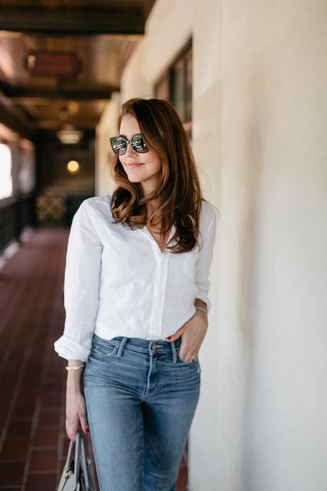 Amy Havins wears a white blouse and jeans.